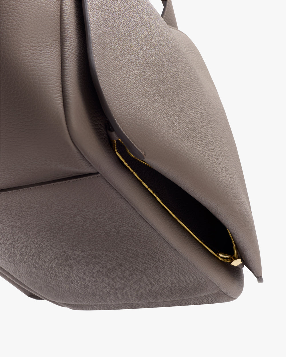 A close-up of a textured bag corner with a zipper.