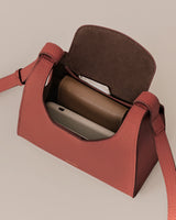 Open handbag with contents including a phone and a wallet inside.