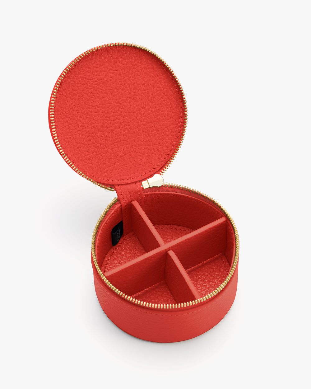 Round jewelry case with open lid showing divided compartments.