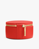 Round zippered travel case with a handle on top.