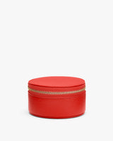 Round zippered case with pebbled texture.