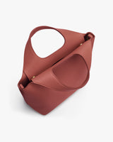 Handbag with round handle and flap pocket.