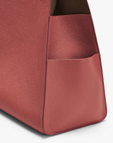 Close-up of a textured corner of a leather bag.