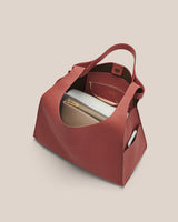 Open handbag displaying purse and small items inside.