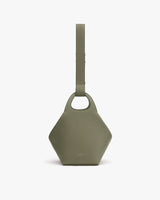 Hexagonal handbag with a wide strap and small handle cutout.