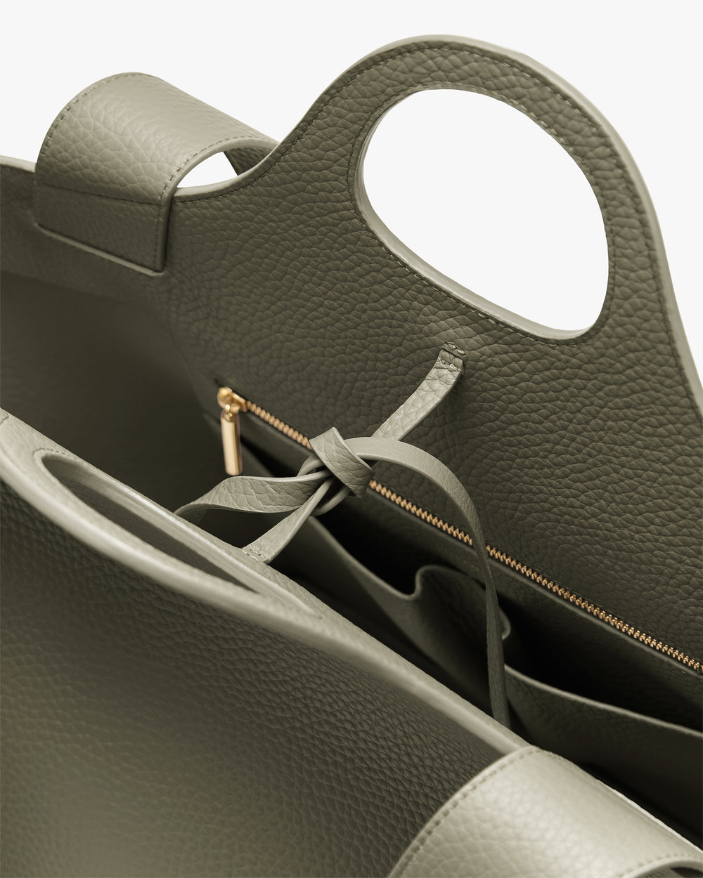 Open handbag with zipper and compartments visible.