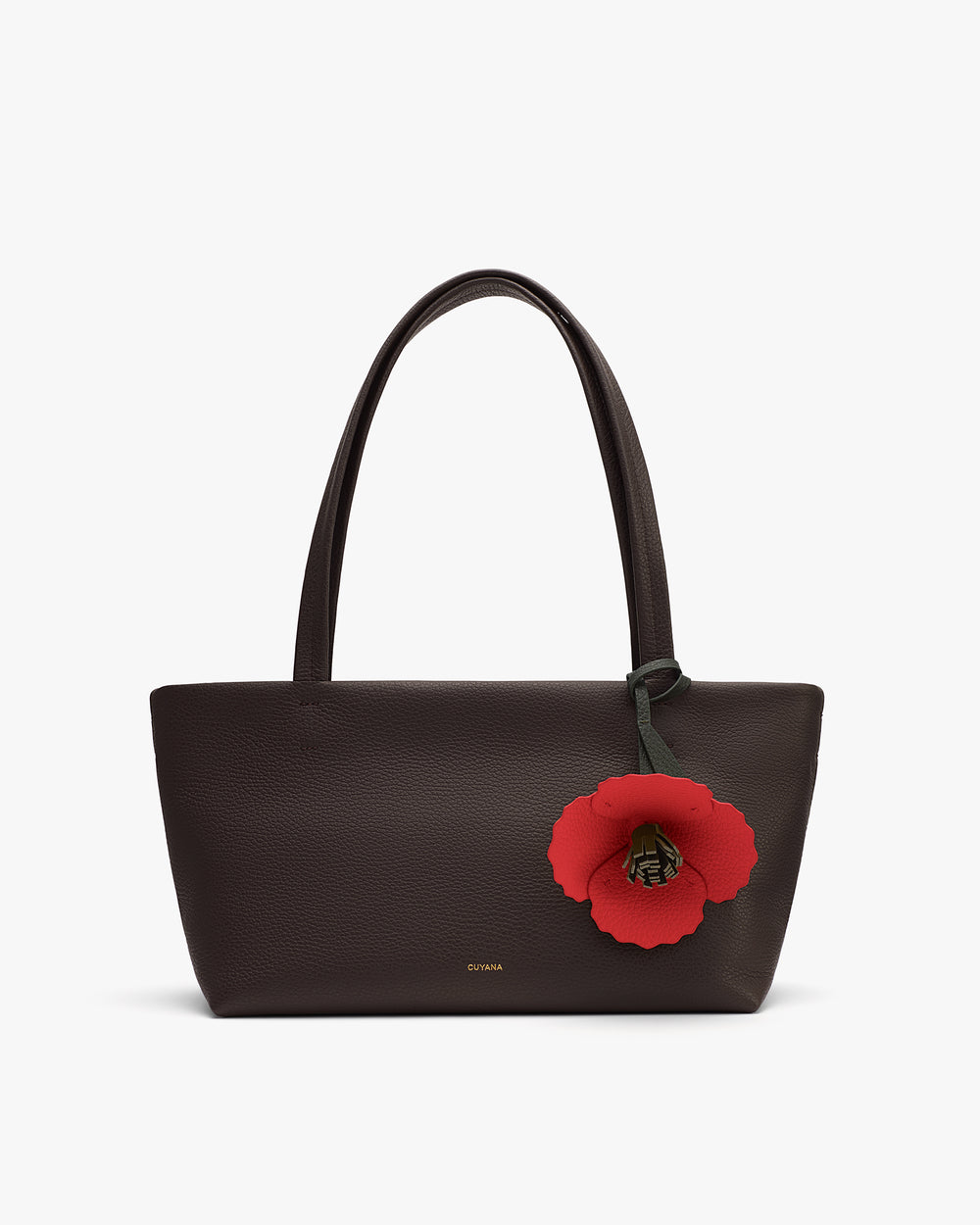 Handbag with long straps and a large flower charm.