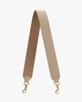 Bag strap with gold clasps on each end