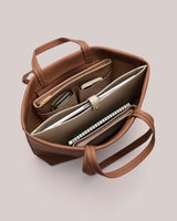 Open tote bag with organized compartments and items inside.