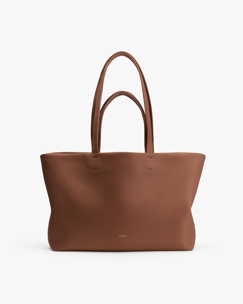 Large tote bag with minimalist design and long handles.