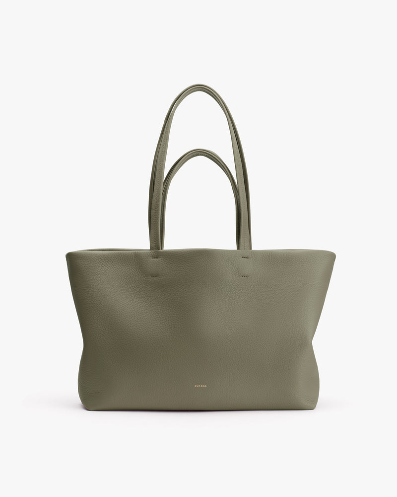 Large tote bag with long handles on white background.