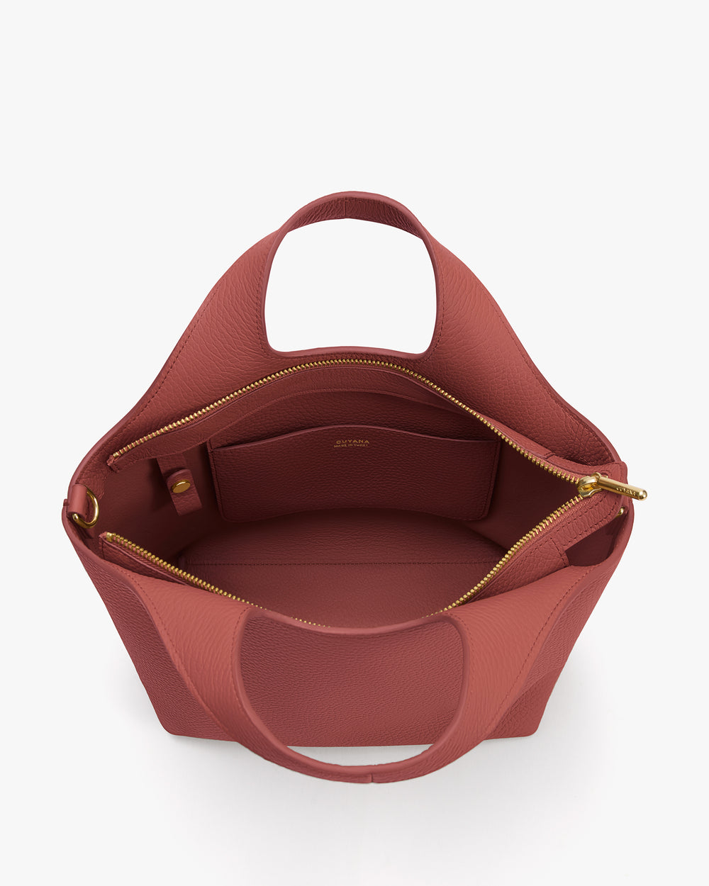 Open handbag with zipper and two handles, showing spacious interior with pocket.