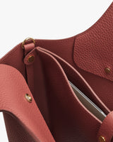 Open handbag with textured surface and visible pocket.