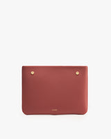 Rectangular clutch bag with small metal studs on the upper corners.