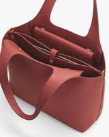 Open tote bag with multiple compartments and long handles.