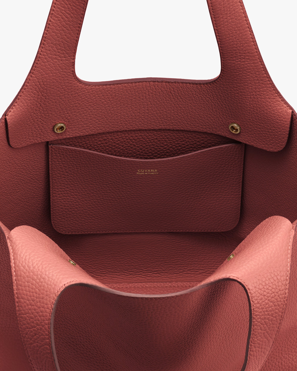 Open handbag with visible inner pocket and button closures.