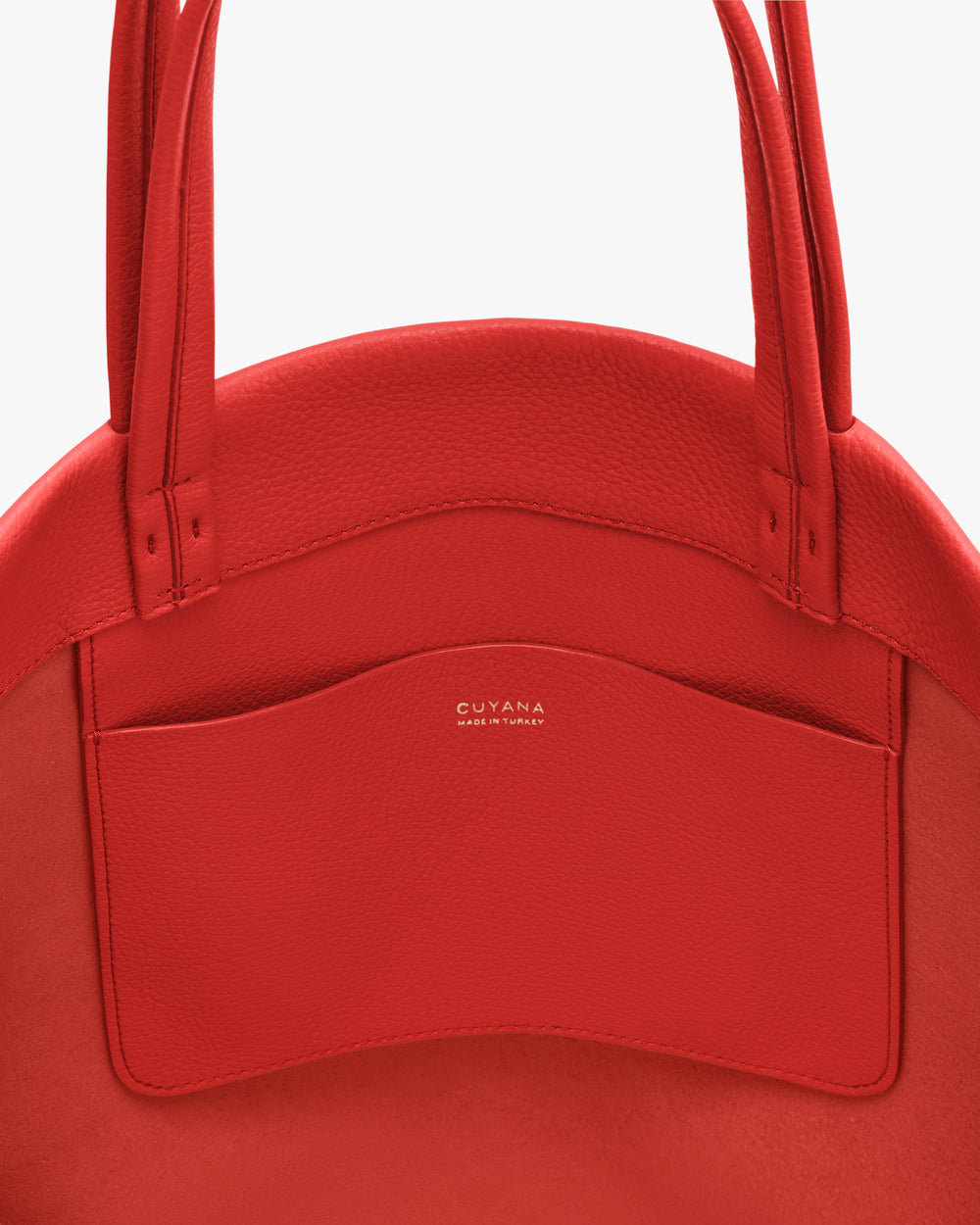 Close-up of a handbag with a visible pocket and handles.