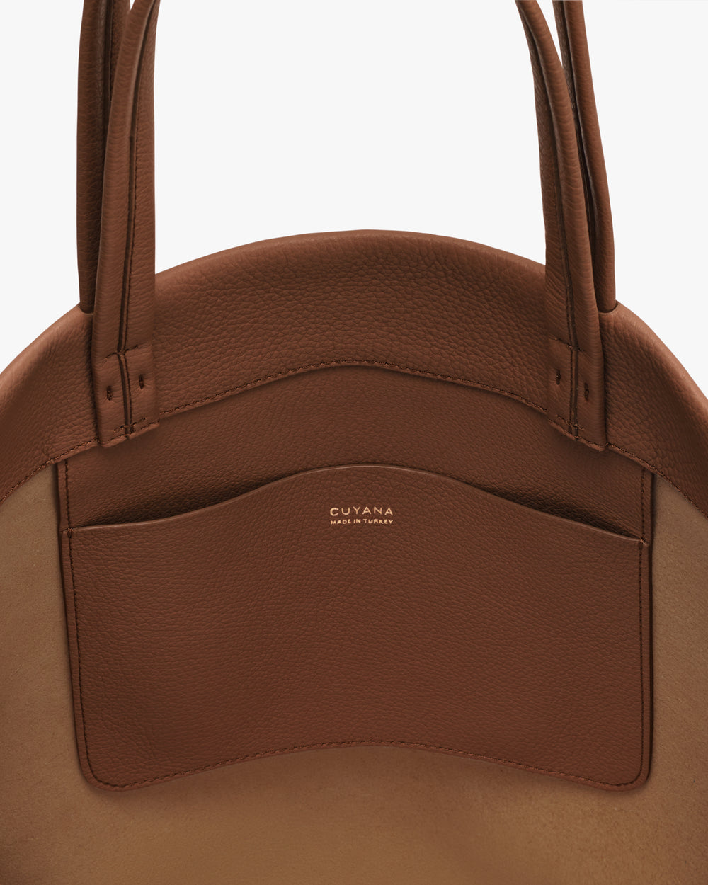 Round bag with two handles and a front pocket.