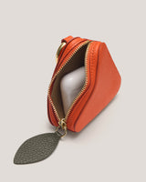 Small triangular pouch open, revealing an AirPods case inside.