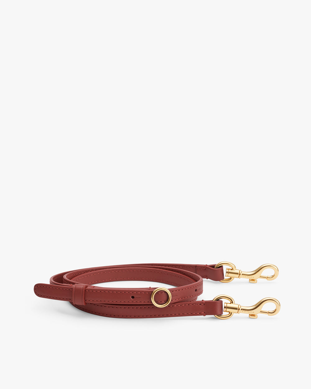 Leather strap with gold-tone clasps and a circular buckle lying flat.