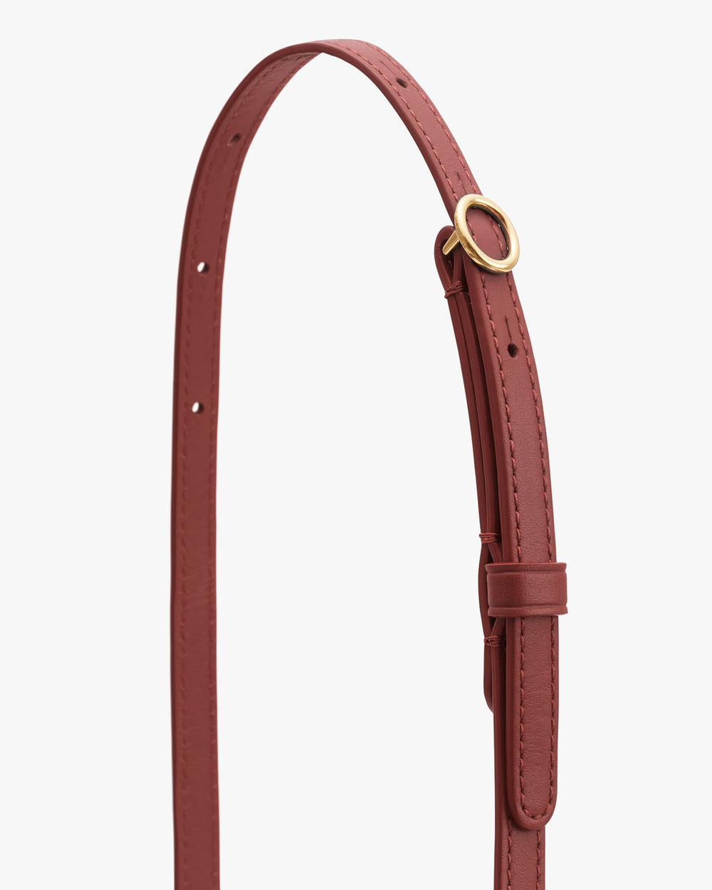 Thin leather strap with metal ring and multiple holes for adjustment.