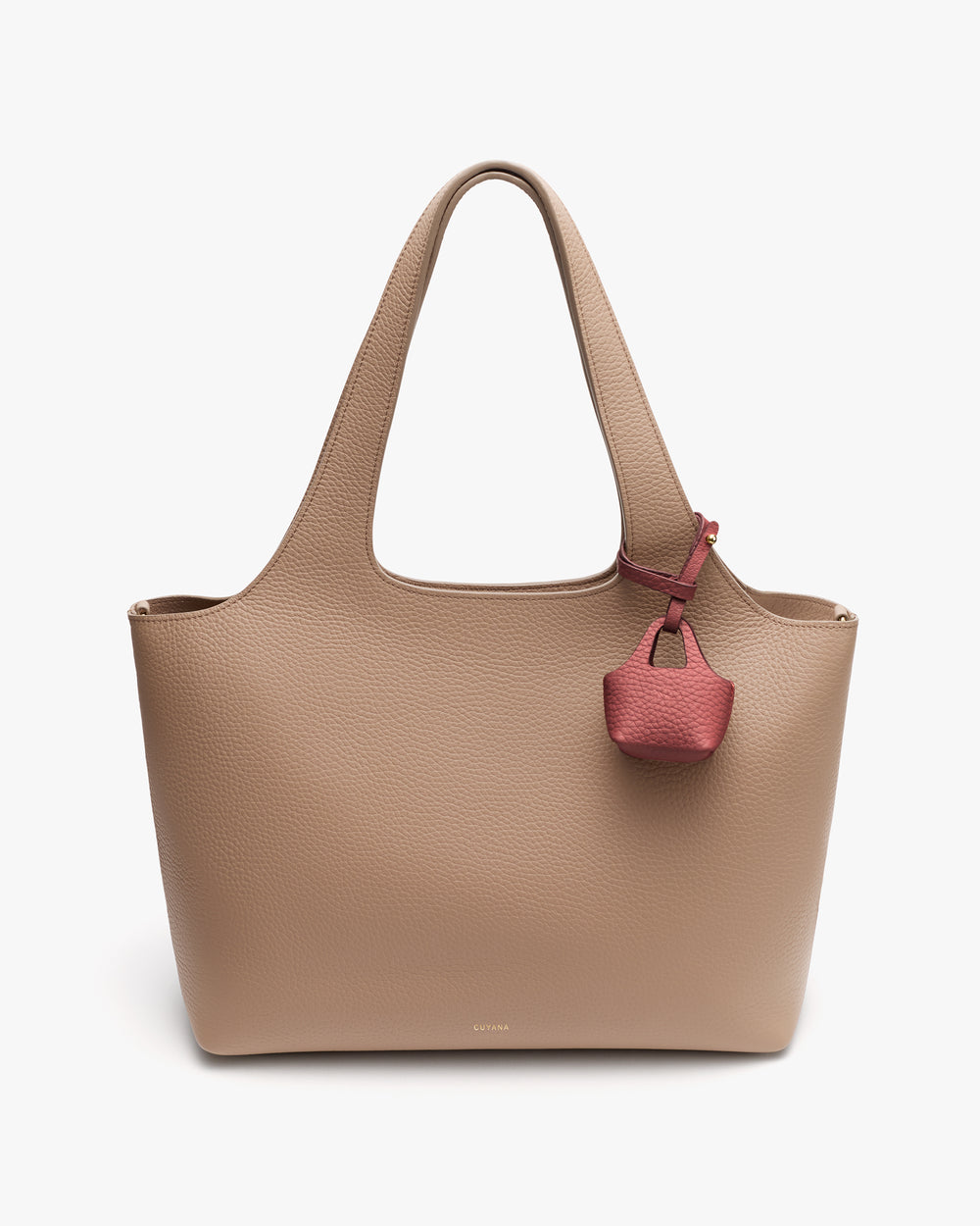 A large tote bag with a small attached charm.