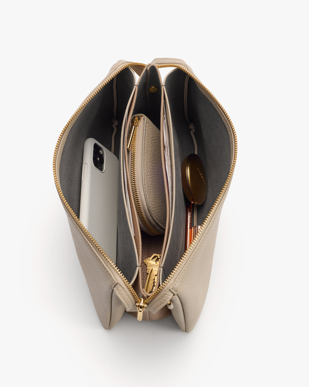 Open handbag with phone, small pouch, and pen inside.