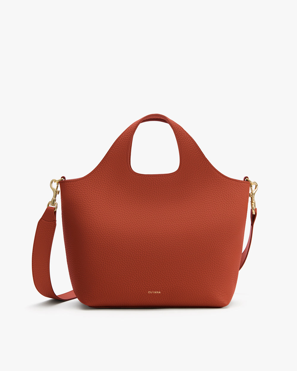 A handbag with a detachable shoulder strap and a rounded handle.