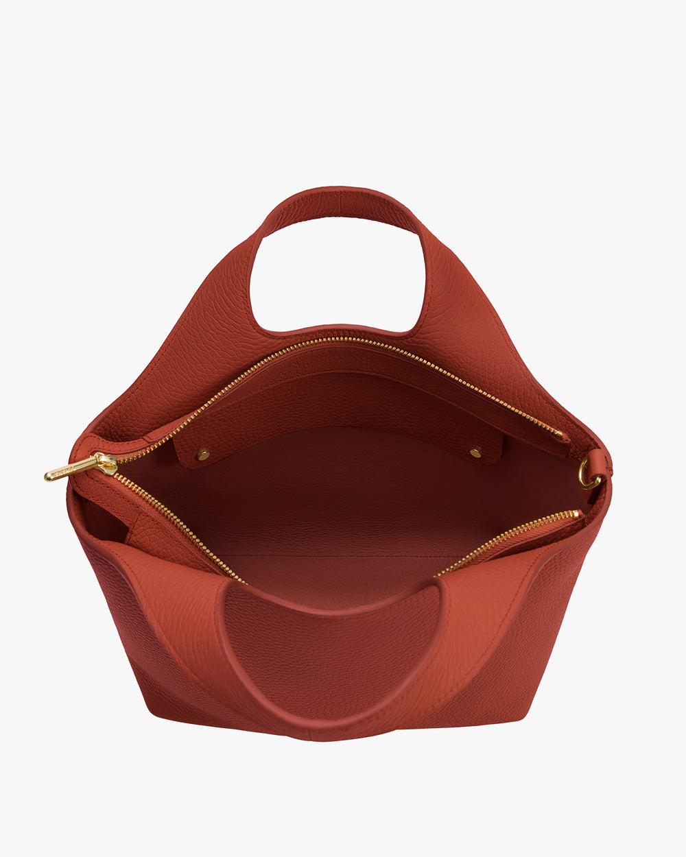 Open handbag with gold zipper and handle, showing interior space.