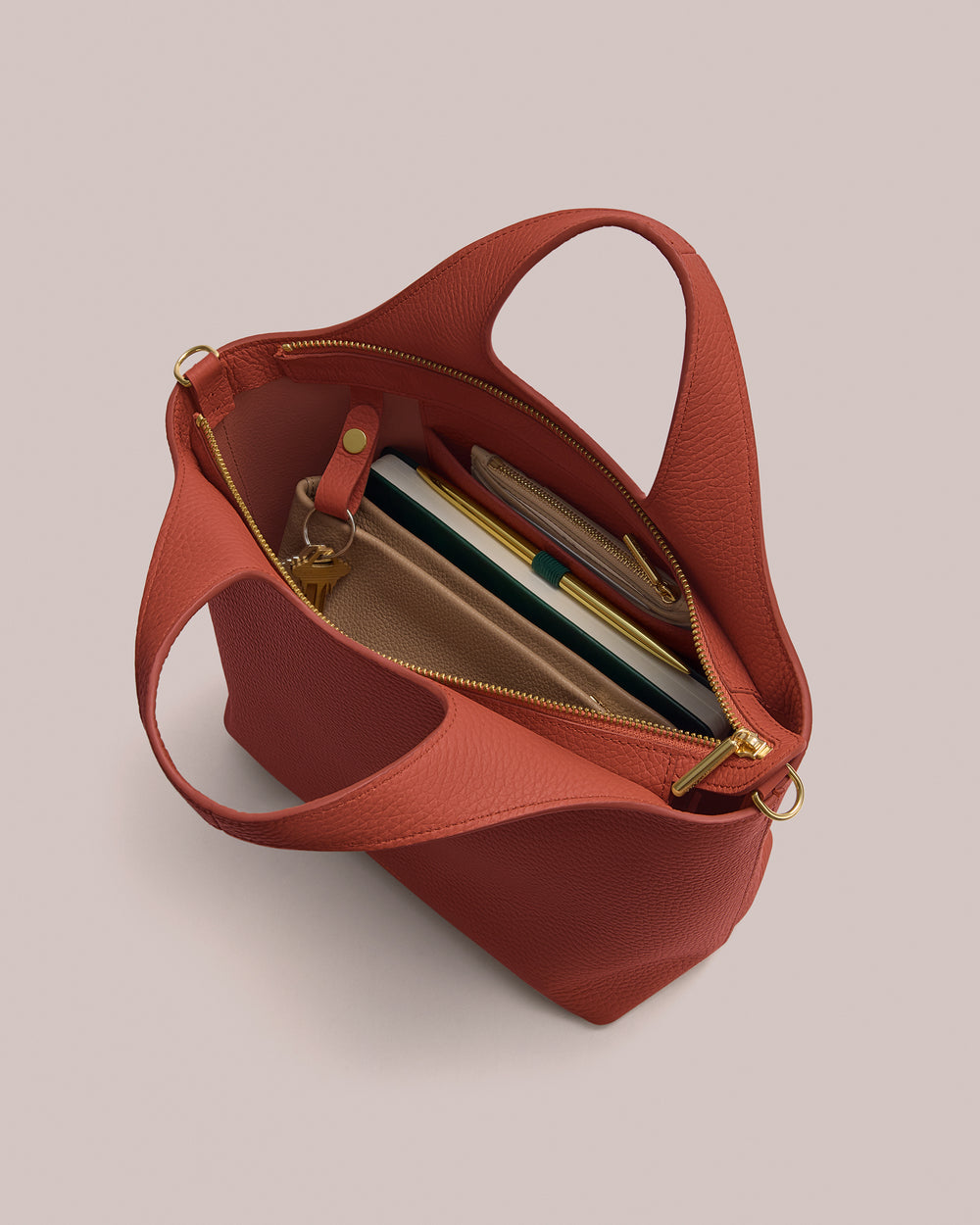 Open handbag with notebooks and pens inside