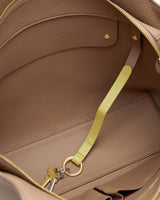Open travel bag showing interior and key attached to strap.