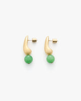 Two asymmetrical earrings with curved shapes and green round beads