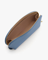 Open zippered clutch bag with spacious interior.