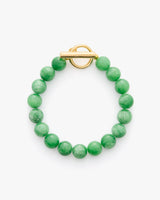 Green beaded bracelet with a gold toggle clasp.