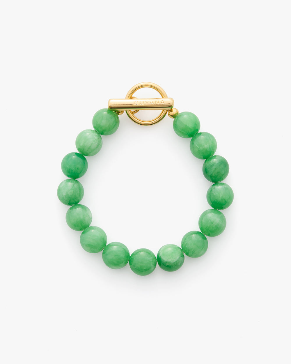 Beaded bracelet with round clasp displayed on a surface.