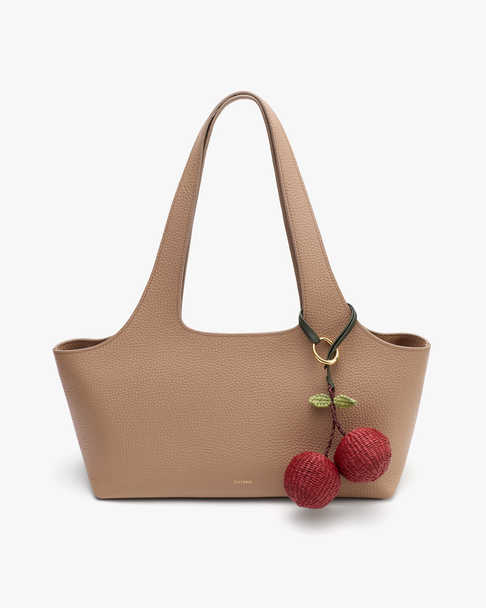 Handbag with a cherry keychain attached to the handle.
