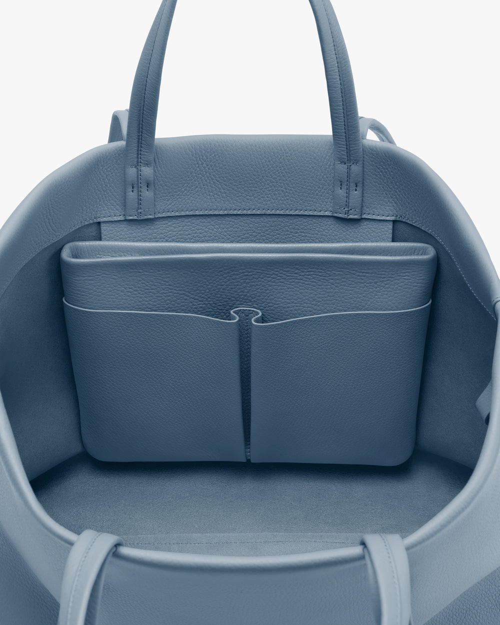Open travel bag with interior compartments and handles visible.