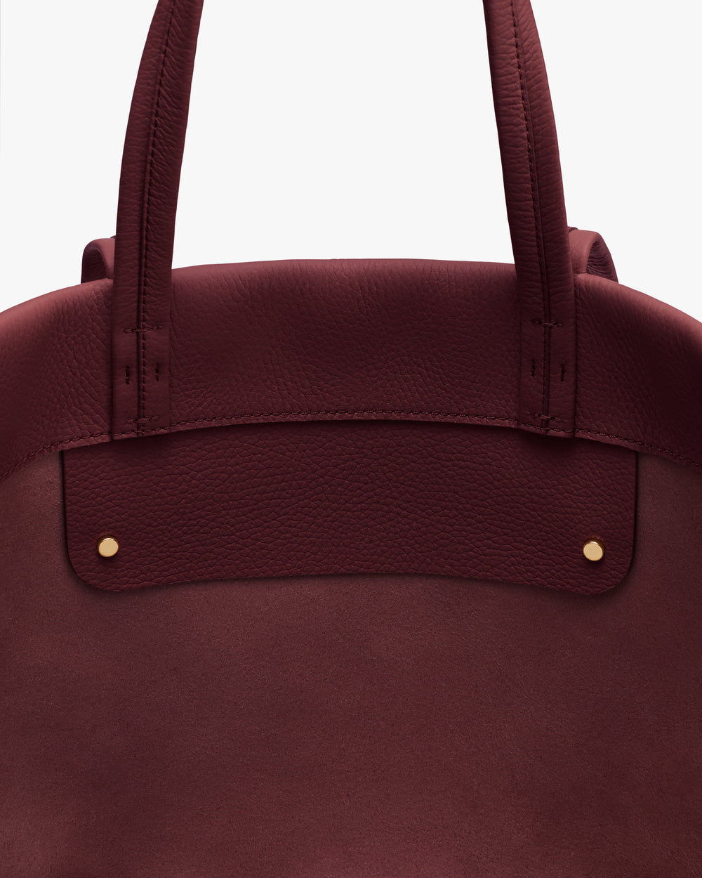 Tote bag with two handles and two small studs at the top.