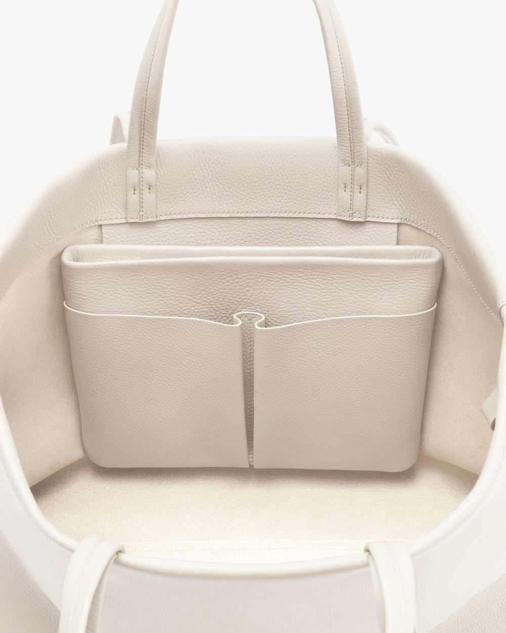 Open travel bag with inner pocket and handles visible.