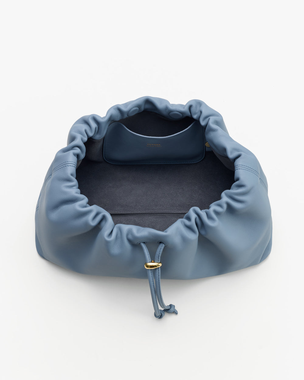 Open drawstring bag with soft interior and attached small pouch inside