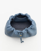 Open drawstring bag with soft interior and attached small pouch inside
