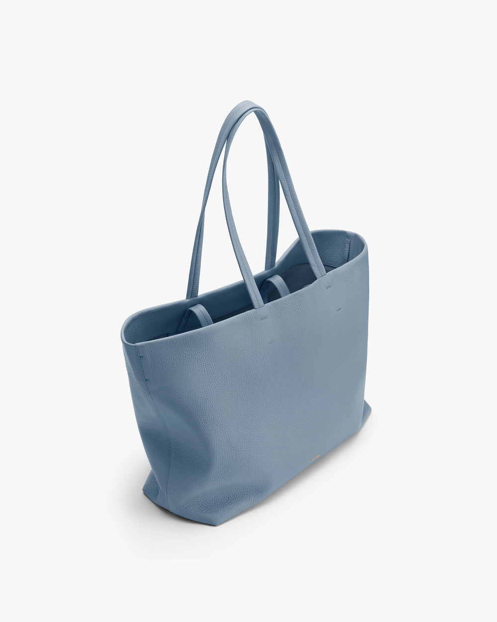 Tote bag with long handles on a plain background.