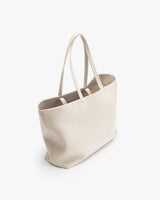 Tote bag with double handles on a plain background.