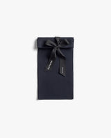 Rectangular fabric pouch with ribbon tied at the top.