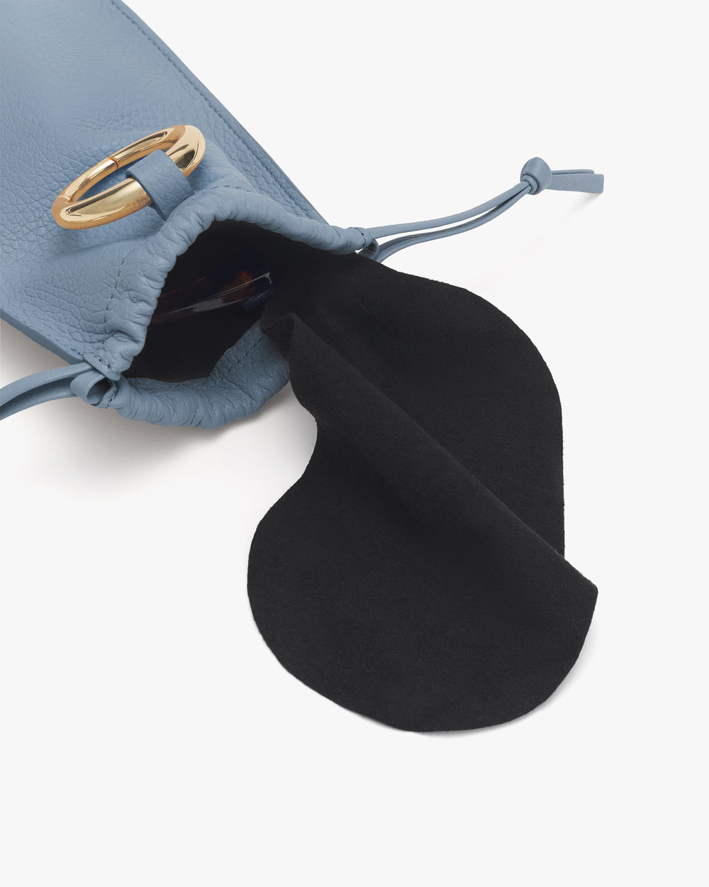 Small drawstring pouch with an open flap and gold metal accent.