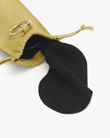 Drawstring pouch opening with a gold buckle visible.