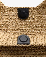 Woven textured bag with a snap button closure.