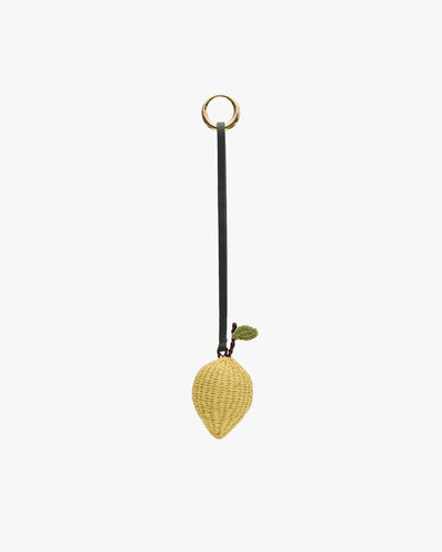 Strawberry-shaped wicker bag charm with a green leaf and looped strap for hanging.