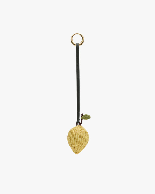 Strawberry-shaped wicker bag charm with a green leaf and looped strap for hanging.