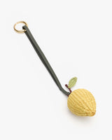 Keychain with a wicker lemon and a strap attached to a metal ring.